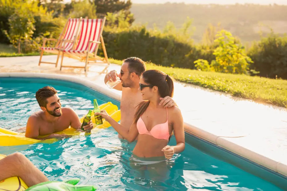Friends enjoying a pool together after the homeowners chose the best pool type for them.